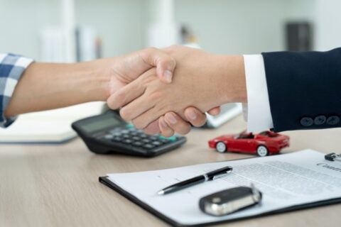 Handshake after signing a title loan contract